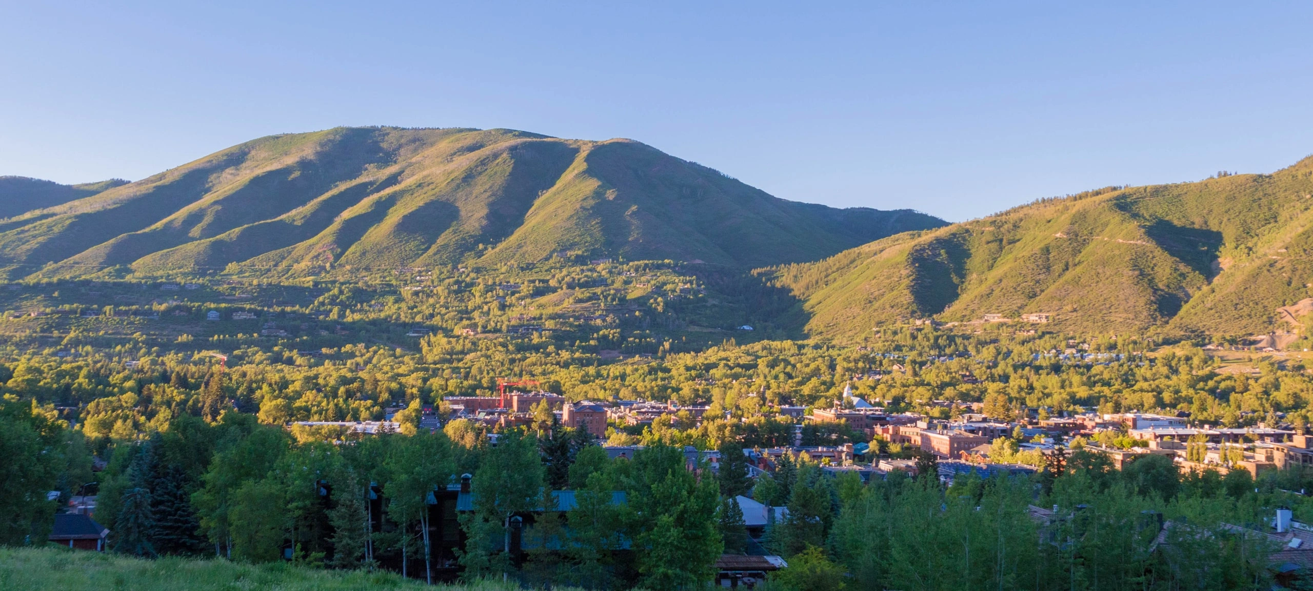 Aerial view of Aspen, CO and mountains during the summertime