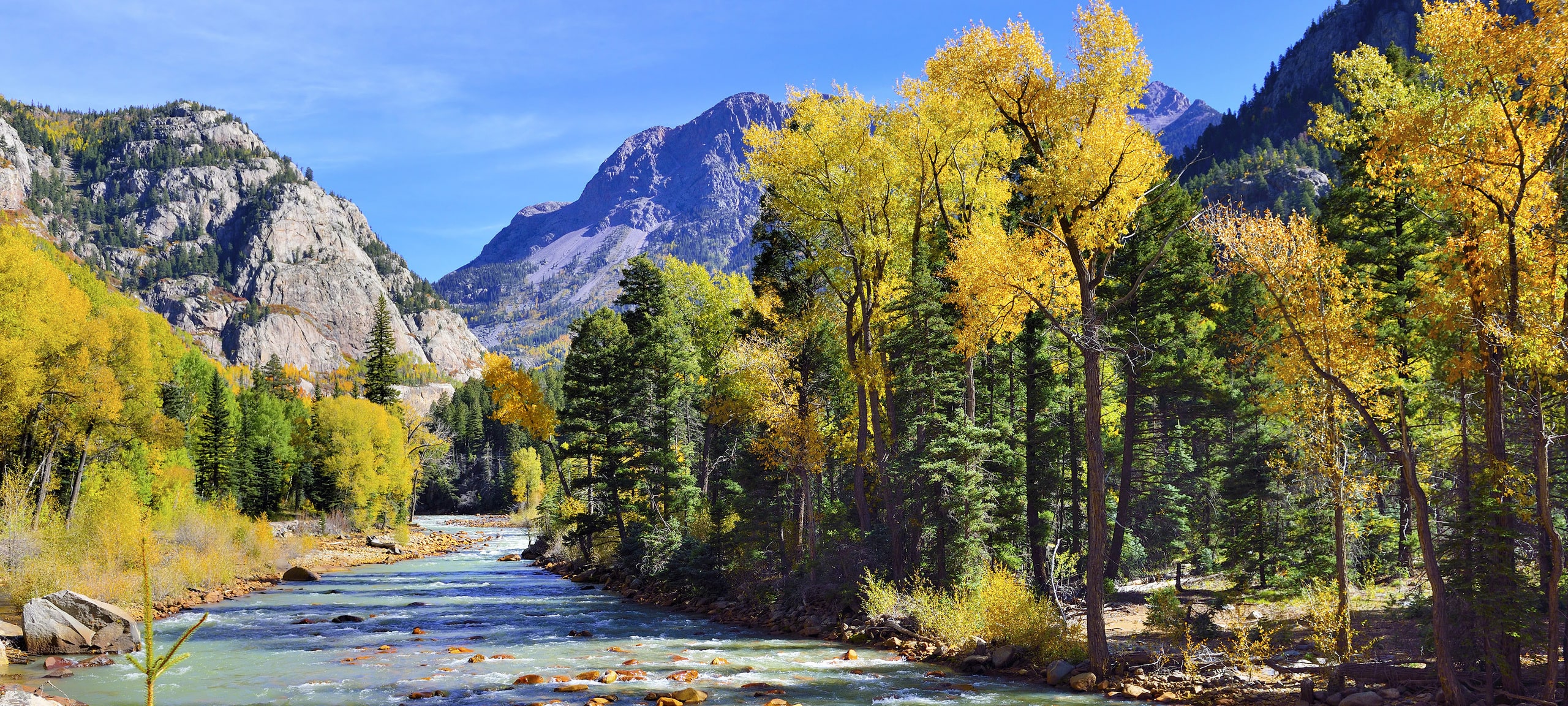 Colorado's Maroon Creek with mountain ranges in background