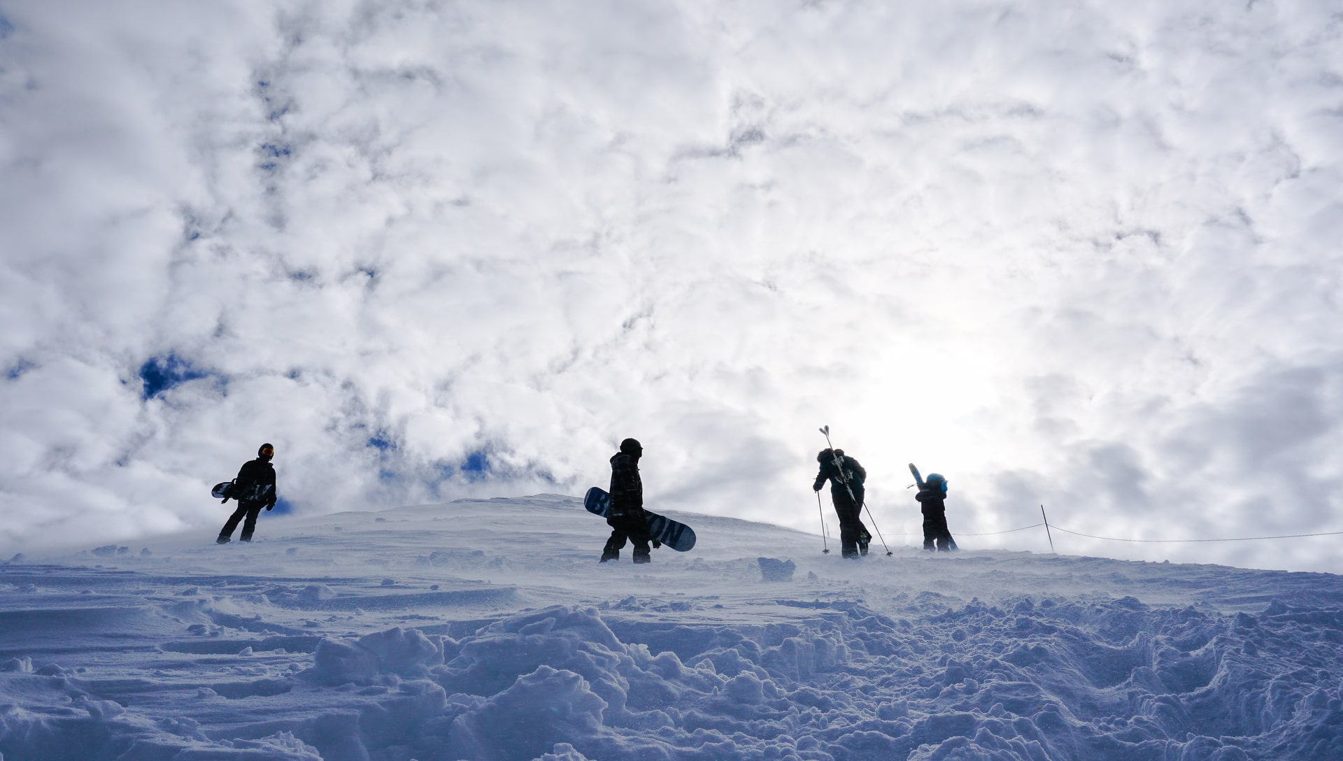 Snowboarders on the snowy Aspen Highlands bowl